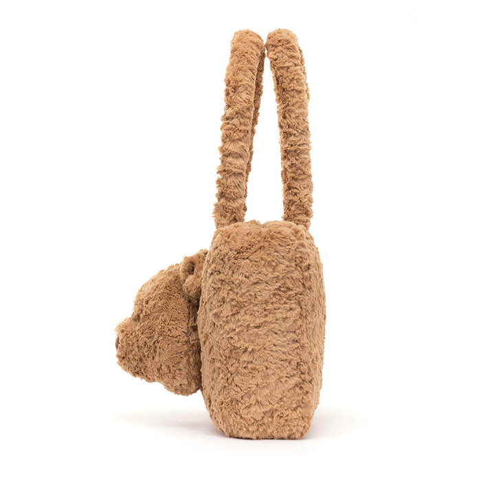 Teddy bear-shaped handbag with a face on a white background
