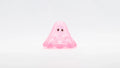 BOO CLEAR PINK GLITTER: A 2cm soft vinyl figure with a playful blob shape, glittery pink translucence, and dark eyes, embodying Strangecat Toys' whimsical art toy style.