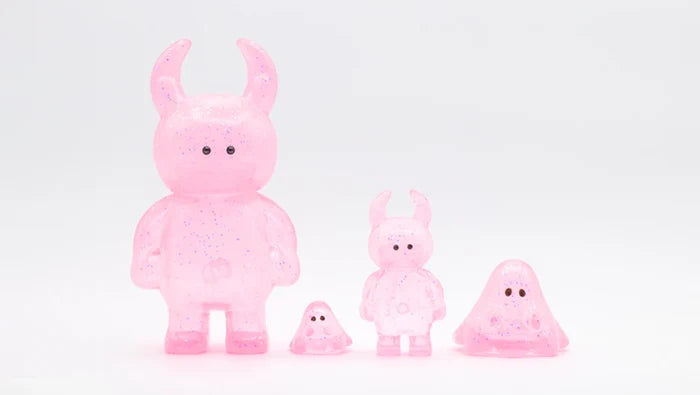 BOO CLEAR PINK GLITTER: Four glittery pink vinyl collectible figures, including horned and blob shapes, showcasing unique designs. Made in Japan, 2cm height.