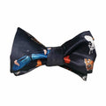 A bow tie with a pattern featuring artistic characters and motifs on a dark background.