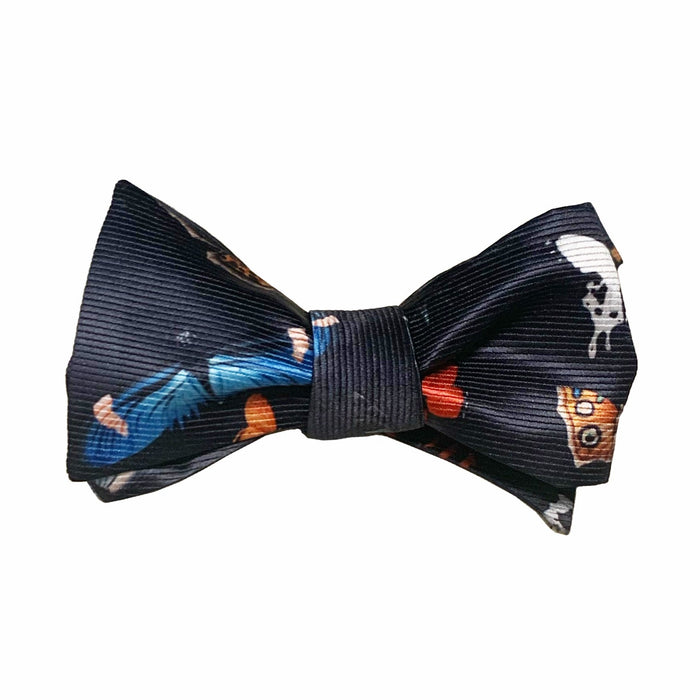 A bow tie with a pattern featuring artistic characters and motifs on a dark background.