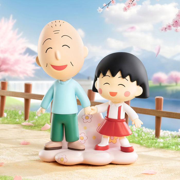 Chibi Maruko Chan's The Time With You Series figures, featuring a chibi elderly man and girl holding hands on a flower-patterned base amidst cherry blossoms.