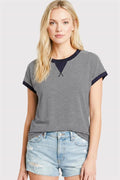 woman wearing navy color trimmed pinstripe top with contrast neckline and sleeves
