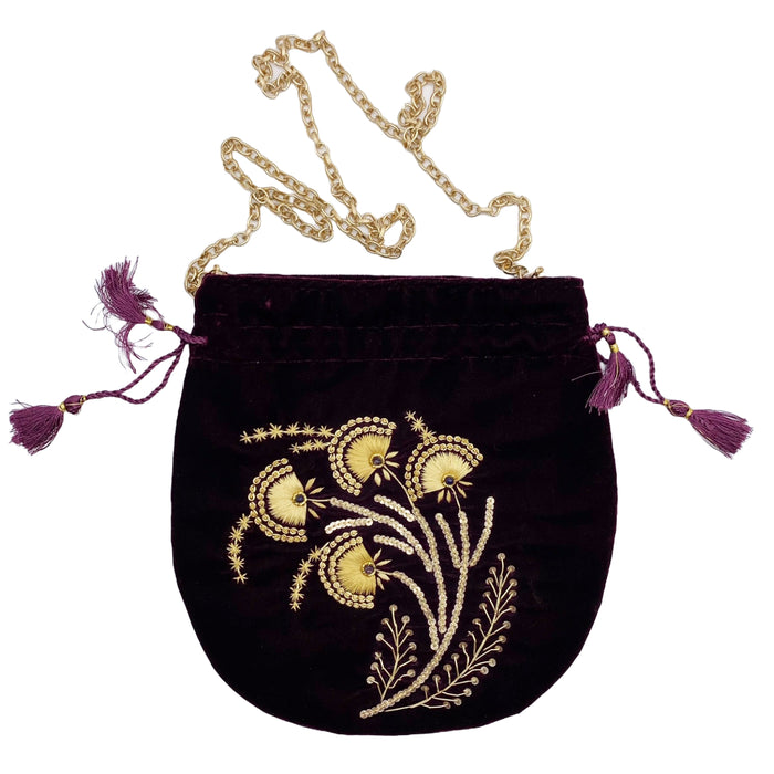 A purple velvet pouch with gold beadwork and embroidery, featuring a gold-toned chain and purple tasseled drawstring.