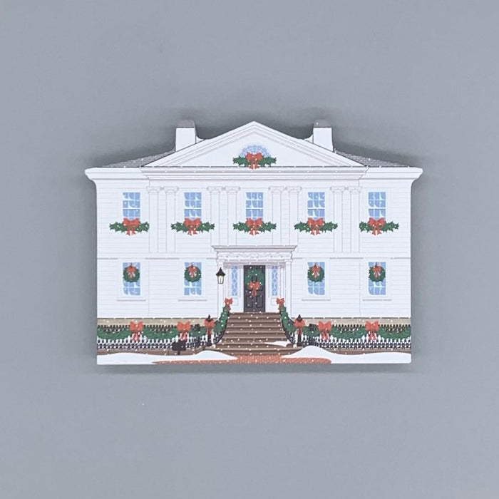 Decorative wood block of the Cotting-Smith Assembly House decorated for the holidays.