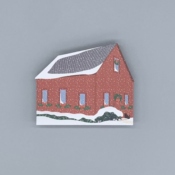 Decorative wood block of the Quaker Meeting House decorated for the holidays.