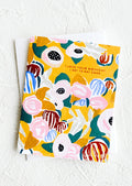 A floral patterned greeting card with yellow background and copper text reading "I love your birthday I get to eat cake".