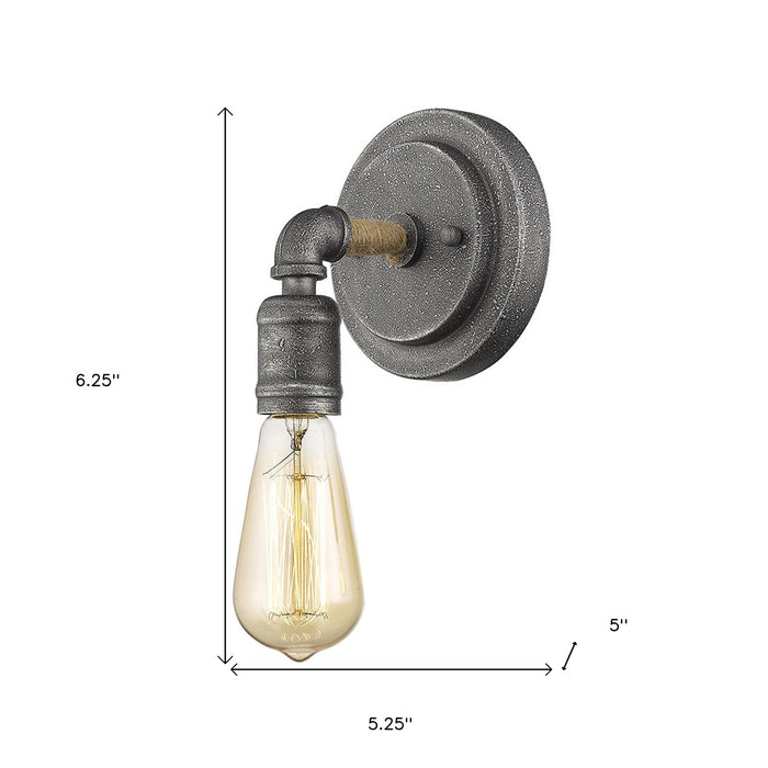 Textured gray industrial wall sconce with exposed Edison-style bulb shown with dimensions of six point two five inches high by five point two five inches wide by five inches deep