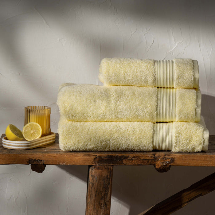 Lemon Yellow  Egyptian Cotton Towels styled in a bedroom | Soak and Sleep