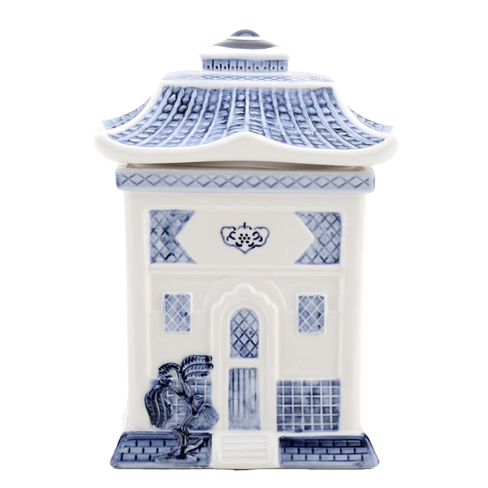 A blue and white porcelain lidded jar with a blue willow embossed design, resembling a traditional Asian pagoda style cookie jar.