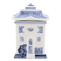 A blue and white porcelain lidded jar with a blue willow embossed design, resembling a traditional Asian pagoda style cookie jar.