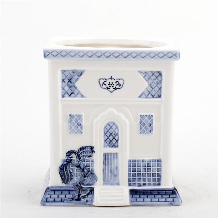 A blue and white porcelain lidded jar with a blue willow embossed design, resembling a traditional Asian pagoda style cookie jar.