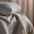Light Grey Herringbone Pure Wool Throws & Cushions - mustard, styled in a bedroom 1 | Soak and Sleep