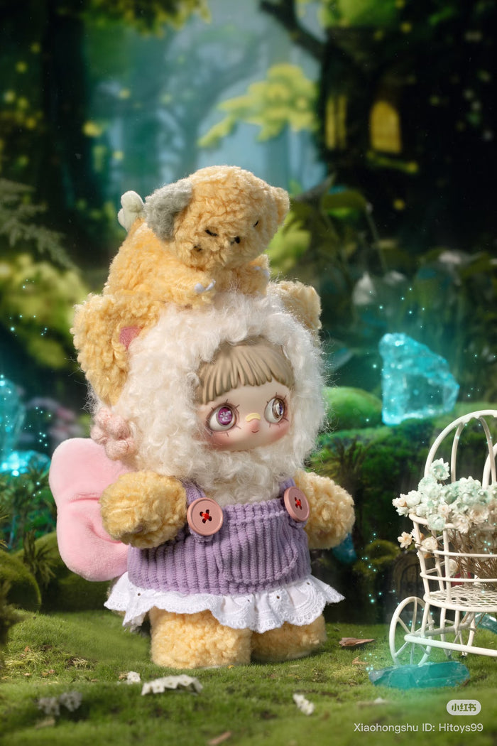 MayMei Symbiote Neverland Series Vinyl Keychain Plush in a whimsical forest, featuring a doll in sheep-like attire with a furry companion atop its head.