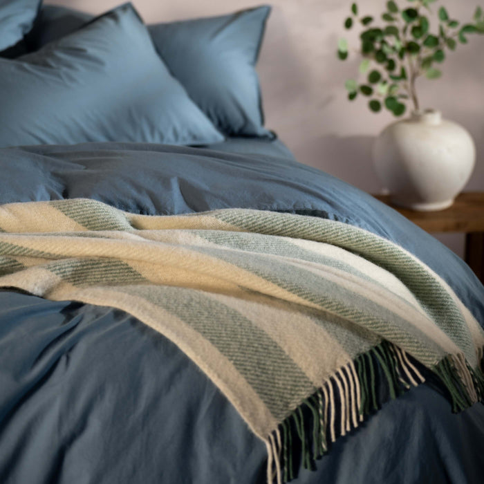 Misty Green Brushed Wool Stripe Throw - breathable, styled in a bedroom | Soak and Sleep