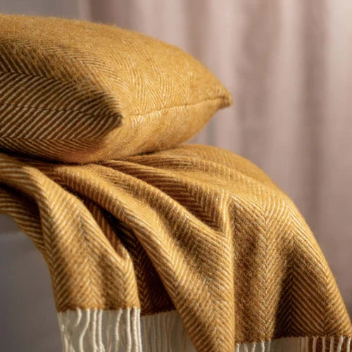 Mustard Herringbone Pure Wool Throws & Cushions styled in a bedroom 1 | Soak and Sleep
