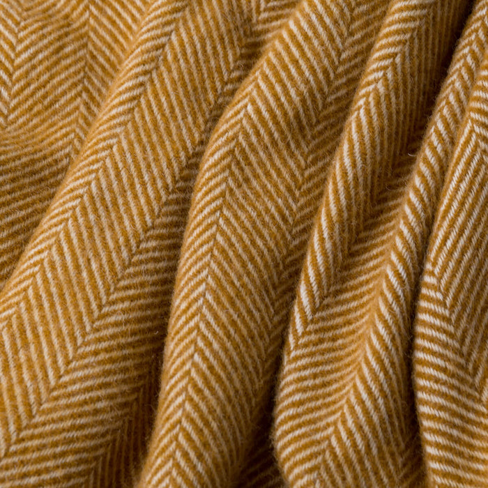 Mustard Herringbone Pure Wool Throw styled in a bedroom | Soak and Sleep