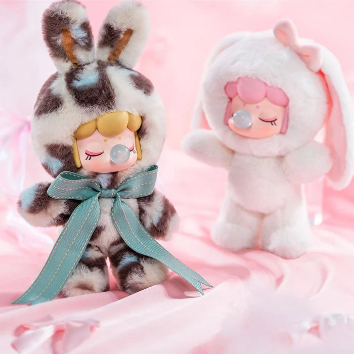 Nanci's Shining Bunny Plush Blind Box featuring a close-up of a stuffed animal with a bow, part of a collectible blind box series.