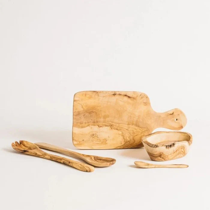 An assortment of olive wood kitchen accessories