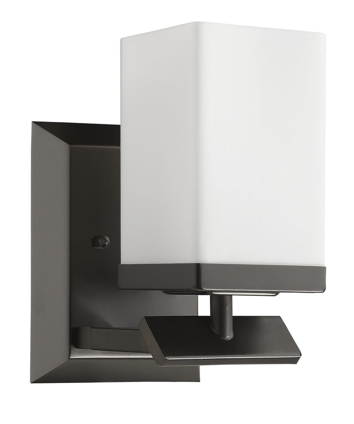 Left side angled view of the One-light bronze wall sconce with cube frosted glass and rectangular backplate