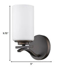 One-light bronze wall sconce with frosted cylindrical glass shade and curved metal arm shown with dimensions of nine point seven five inches high by five inches wide