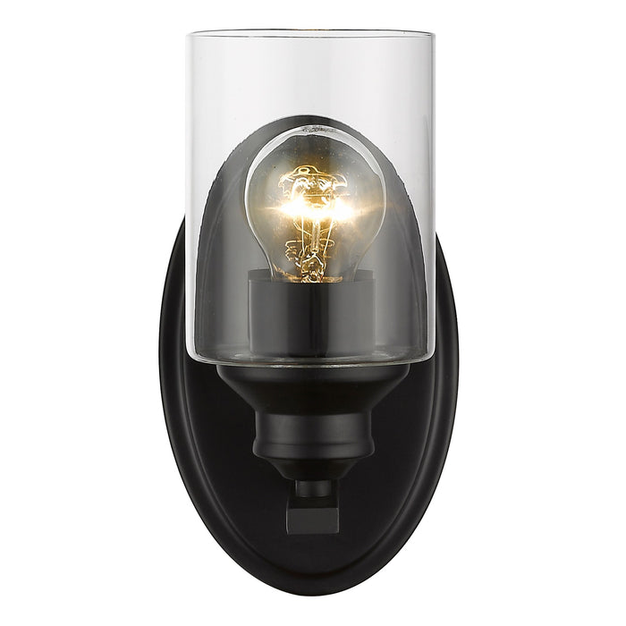 Front view of the lighted One-light matte black wall sconce with cylindrical clear glass shade and modern backplate