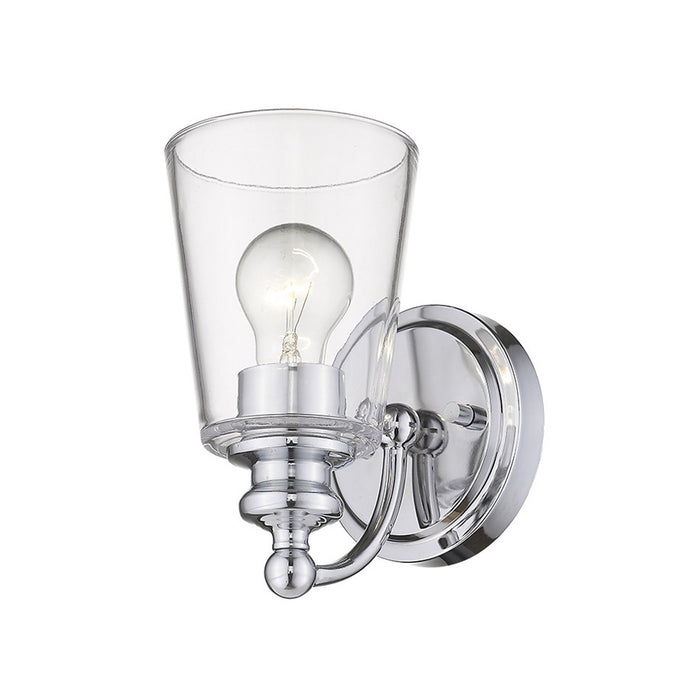 Bottom up angled view of the lighted One-Light Silver Wall Sconce with clear tapered glass shade and polished chrome finish