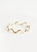 A gold stacking ring in curvy ripple shape.