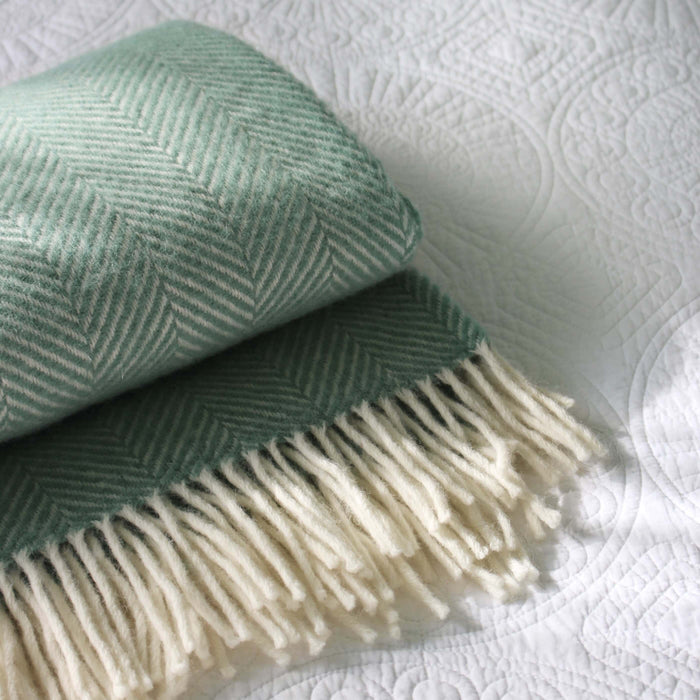 Sea Green Herringbone Pure Wool Throw in a styled bedroom 2 | Soak and Sleep