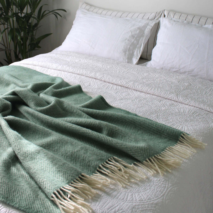 Sea Green Herringbone Pure Wool Throw in a styled bedroom 3 | Soak and Sleep