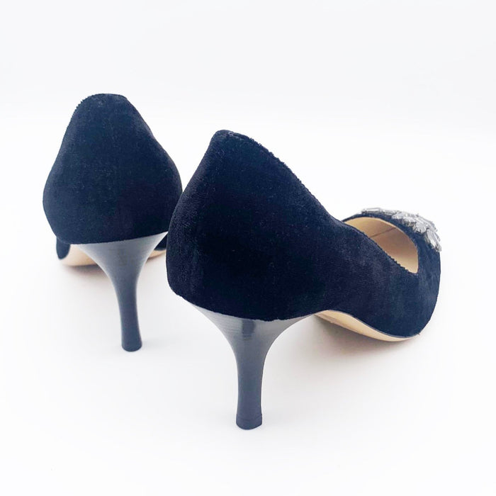 A pair of black velvet high-heeled shoes with dark grey rhinestone embellishments on the front, designed by Emma Hope.