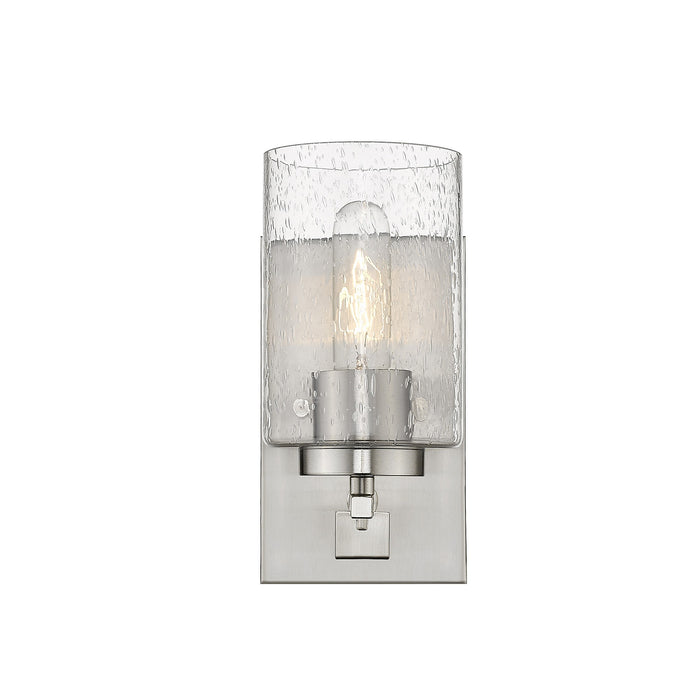 Front view of the lighted Silver metal wall sconce with raindrop-textured glass shade, modern single-light design