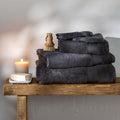 Smoke Egyptian Cotton Bath Towels styled in a bedroom | Soak and Sleep