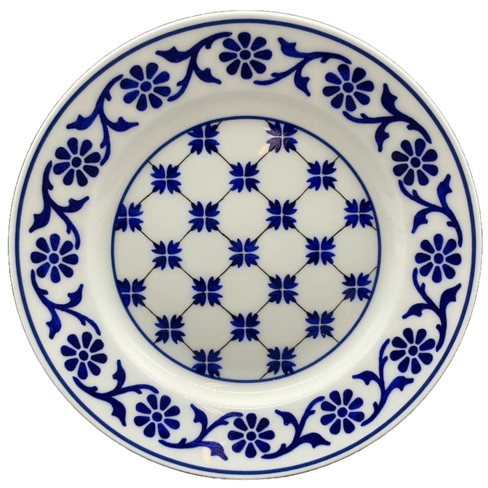 A round porcelain tea plate with a blue and white floral pattern reproduced from the Ropes Mansion fireplace surround tiles.
