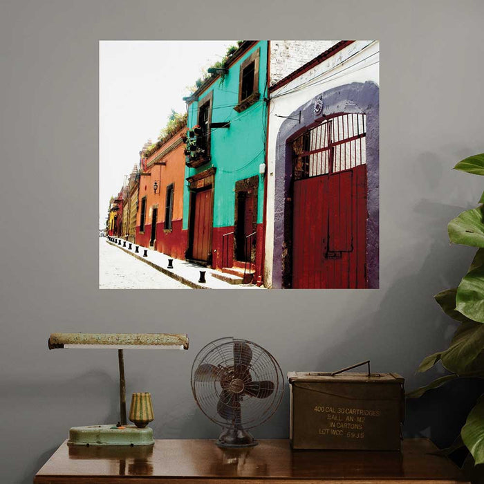 36 inch colorful Mexican street architecture decal with buildings installed on a gray wall above a wooden table
