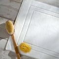 White Egyptian Cotton Bath Mat styled in a bedroom | Soak and Sleep