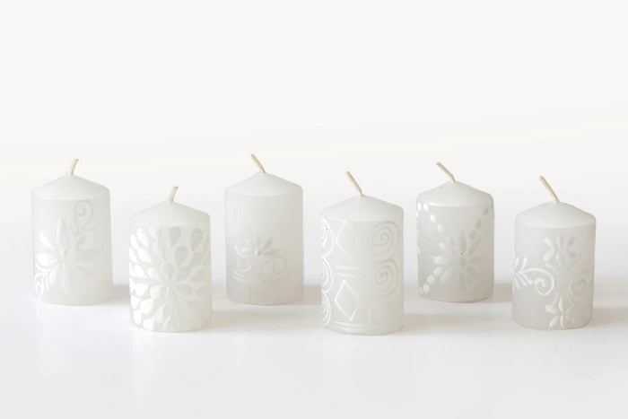 Set of white embossed candles on a white background