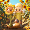Zsiga Take It Slow Series Figures: sunflower-person and childlike character with snail toy, set in a sunflower field.